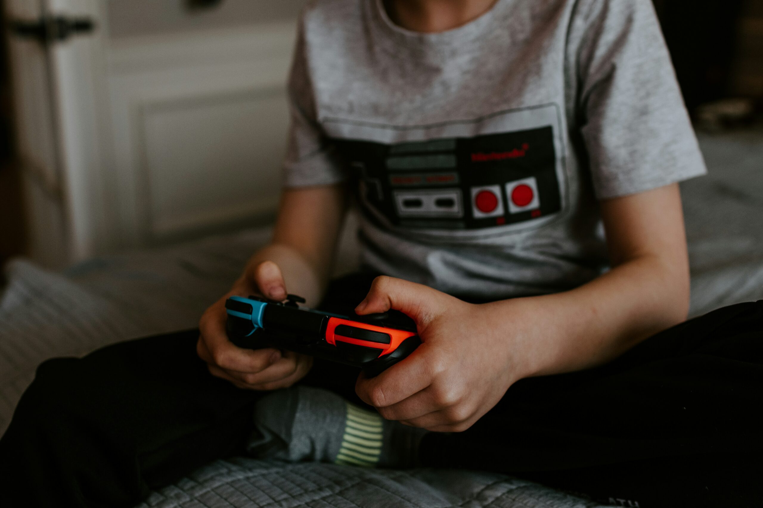 Boy playing video game during his hobby time